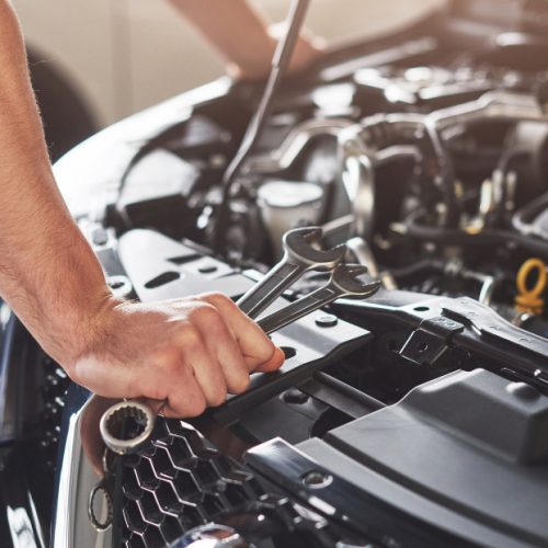 muscular-car-service-worker-repairing-vehicle-1